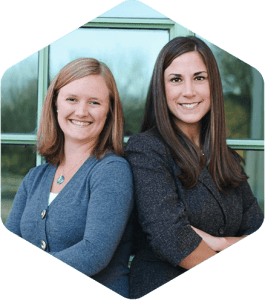 Job share team Beth Malmin and Angela Detviler standing back-to-back